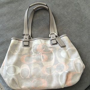 Medium size logo Coach hand bag. Leather handle and trim. Grey with pastel “C”s